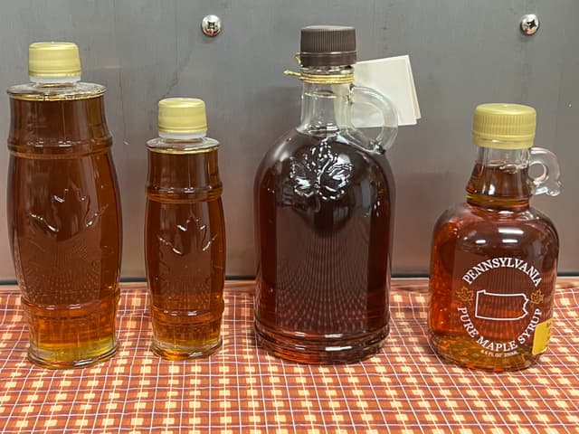 Specialty glass maple syrup containers.  The barrel is tall and skinny and looks a bit like a beer can. The gallone looks more like a liquor bottle with a convenient little handle for keeping the sticky syrup off your fingers. The classic barrel is a tall slender glass container.